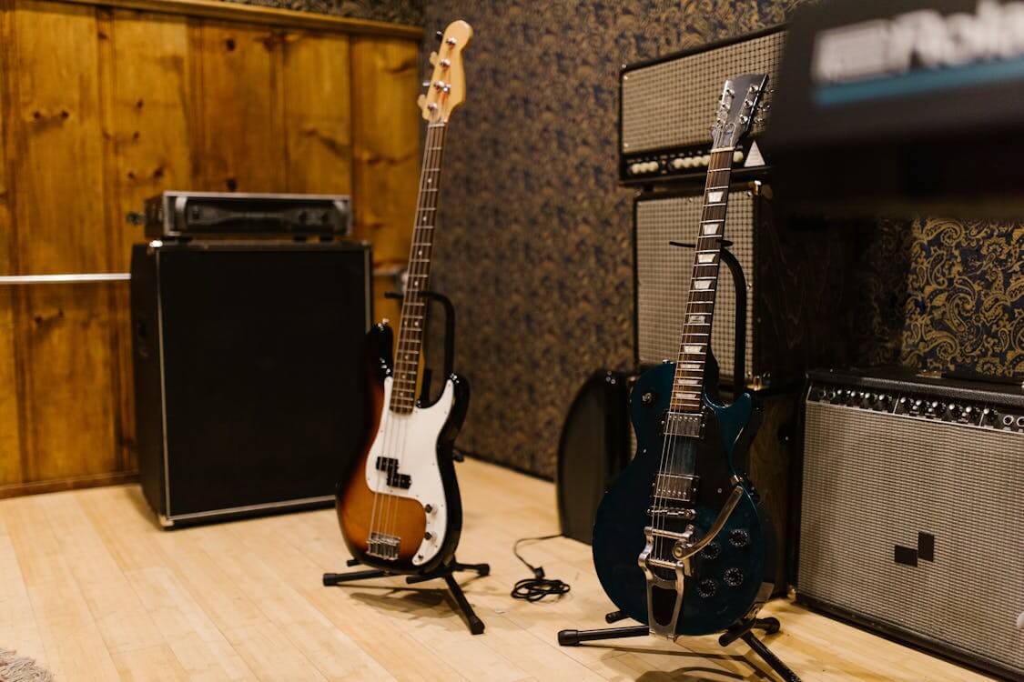 An amplifier and several electric guitars in a professional studio