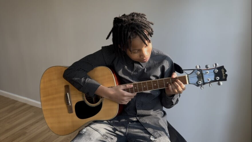 A passionate music student playing an instrument